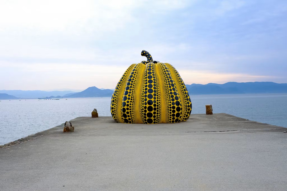Yayoi Kusama Yellow Pumpkin sculpture on Naoshima Island pier