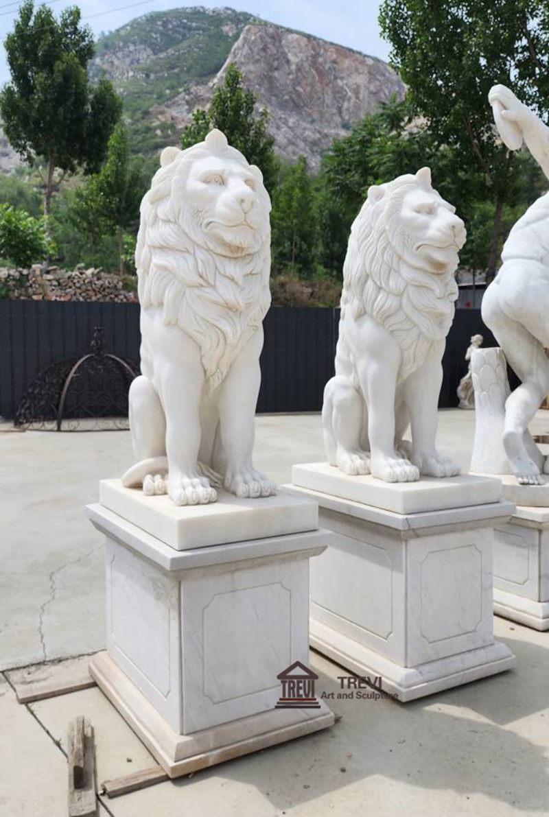 white sitting lion statue by Trevi