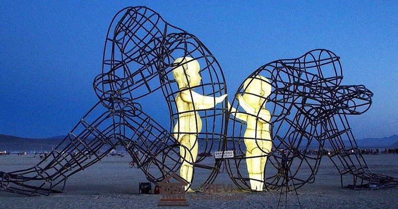 Two adults back to back sculpture