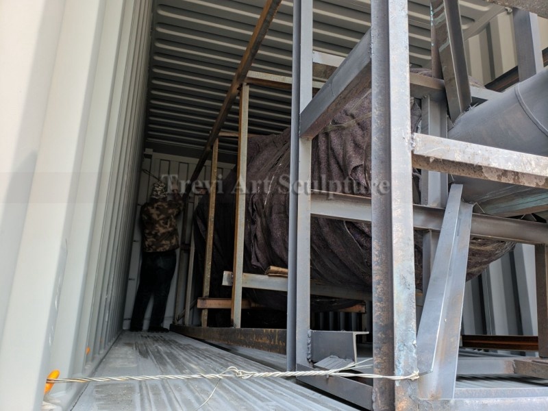 Bronze military statue being transported to the memorial site