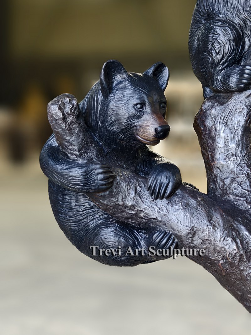 Bronze bear climbing tree sculpture