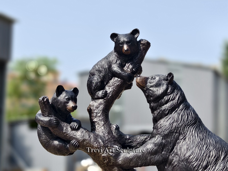Bronze bear climbing tree statue details