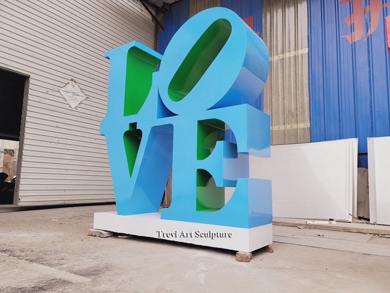 blue metal letter sculpture