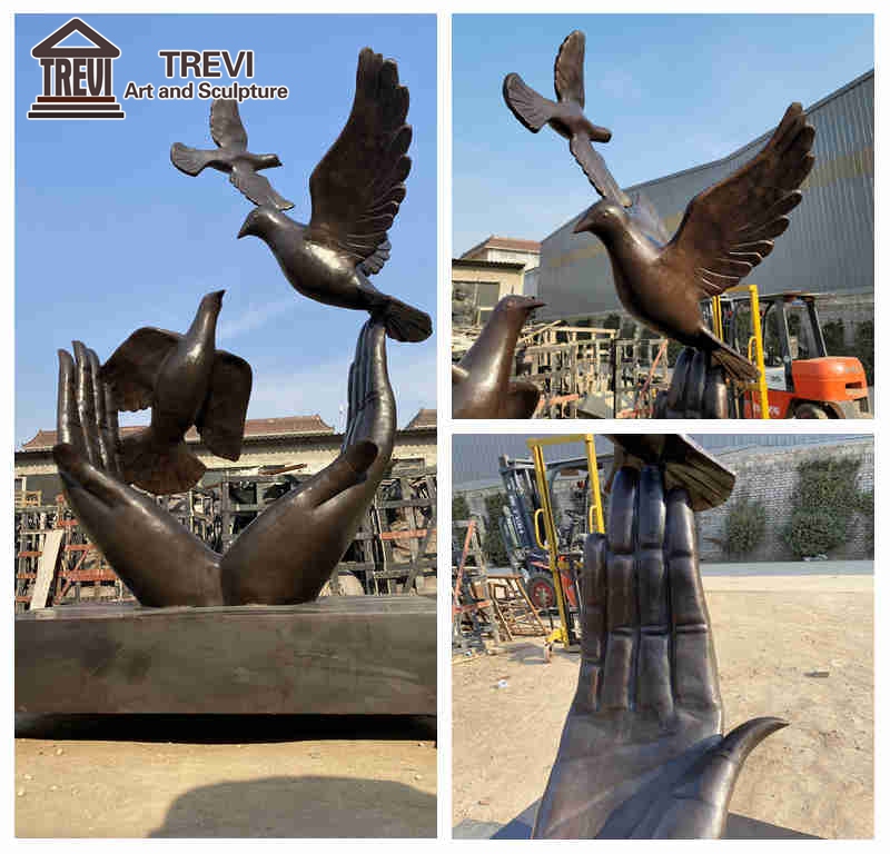 bronze hand and dove sculpture detail