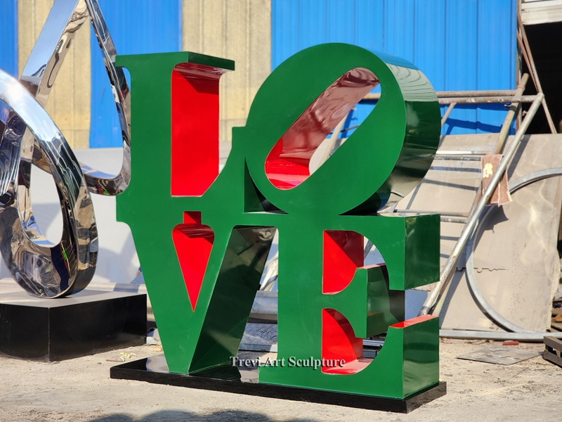 green metal letter sculpture