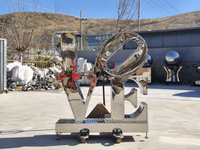 polished metal letter sculpture