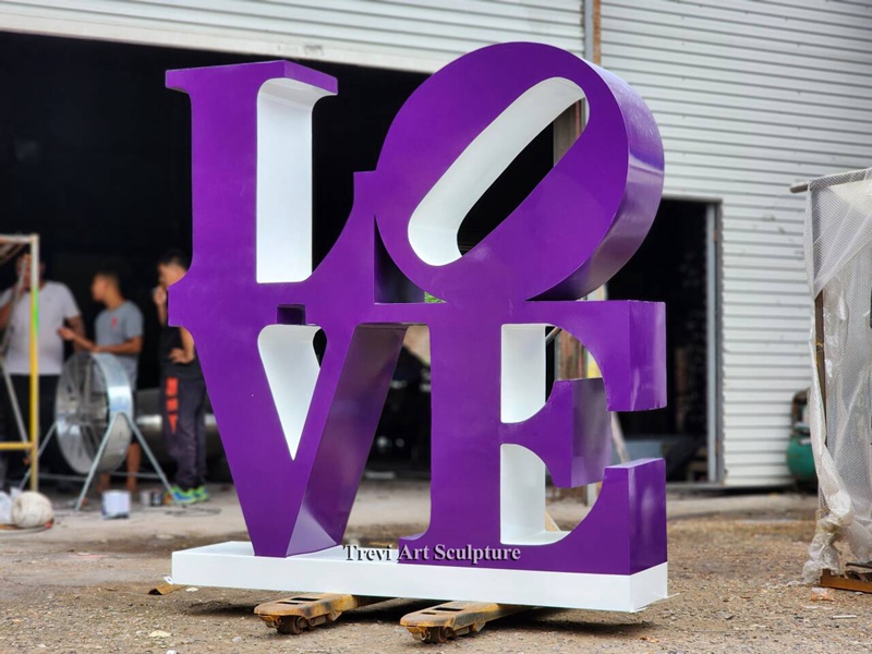 purple metal letter sculpture