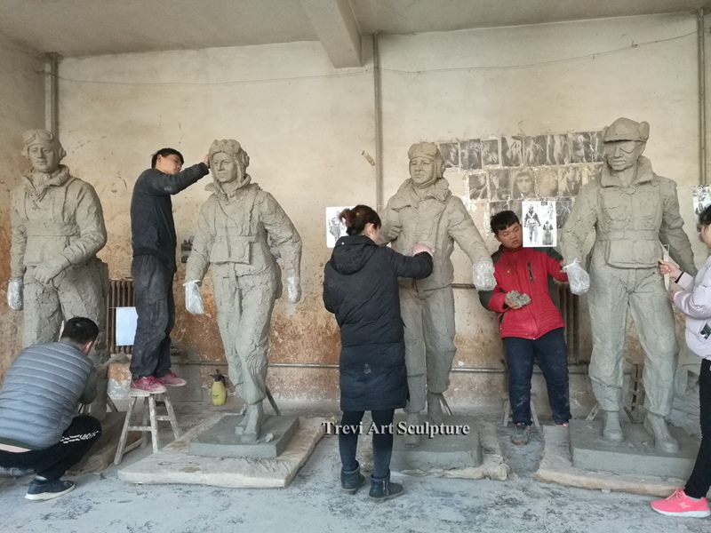 The artist team refines the clay model of the Tuskegee Airmen.