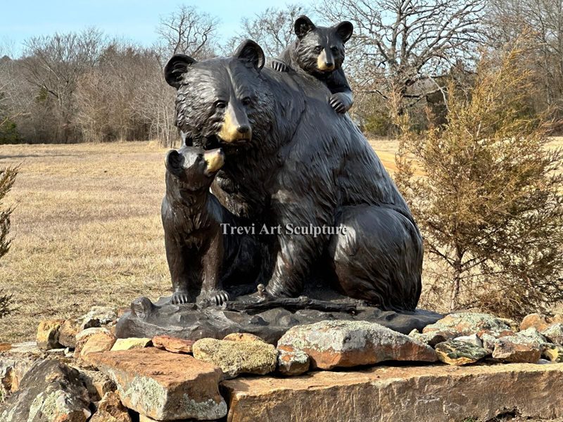 Black Bear Family — installed on a natural stone base near the ranch water feature