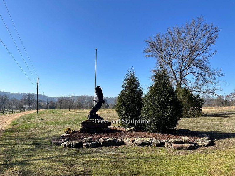 Bronze Eagle — mounted on a rock pedestal beside the ranch flagpole