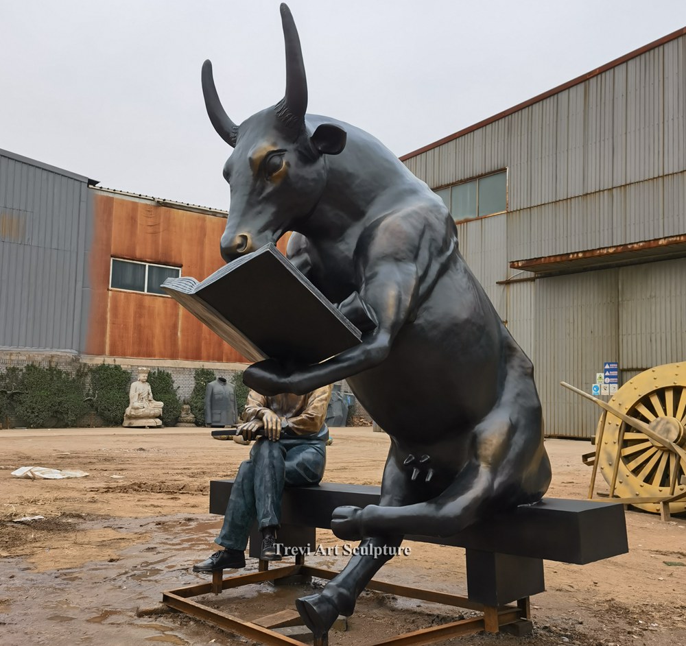 bronze Man and reading cow statue