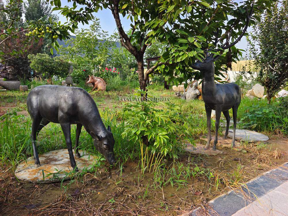 bronze deer and tree sculpture