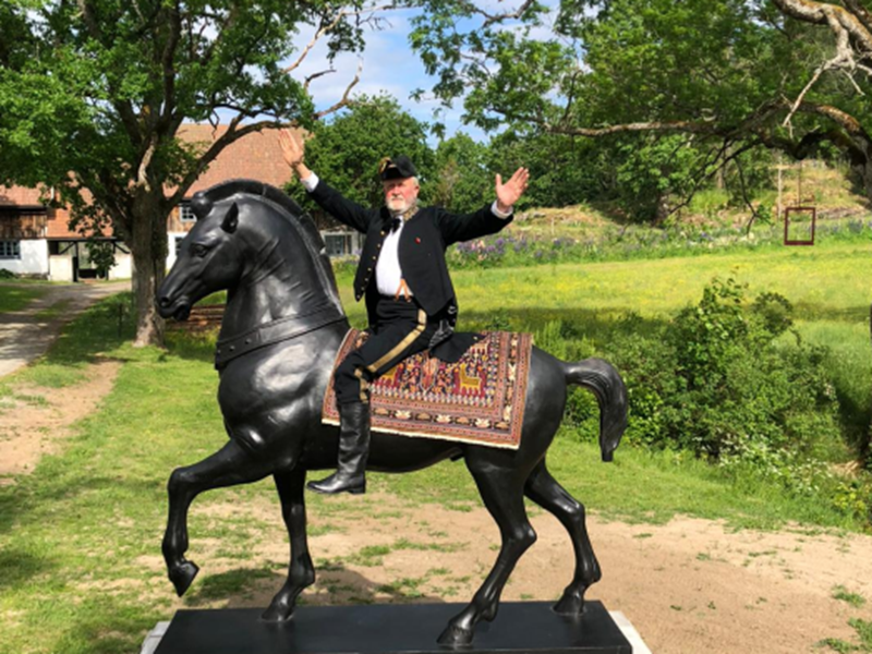 Customer setting with bronze horse sculpture and rider outdoors
