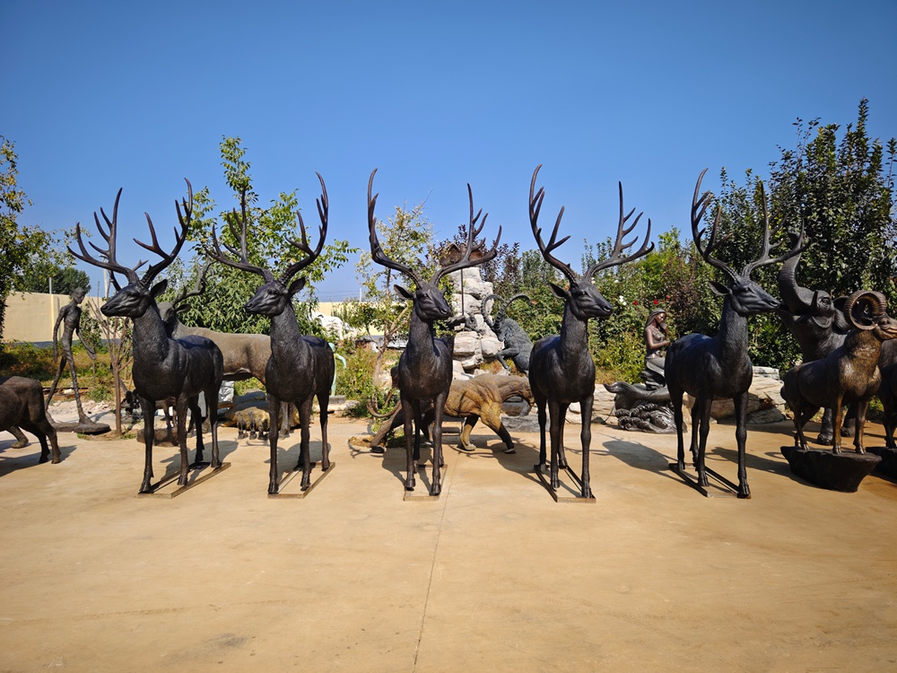 Five bronze stag sculptures viewed from the front