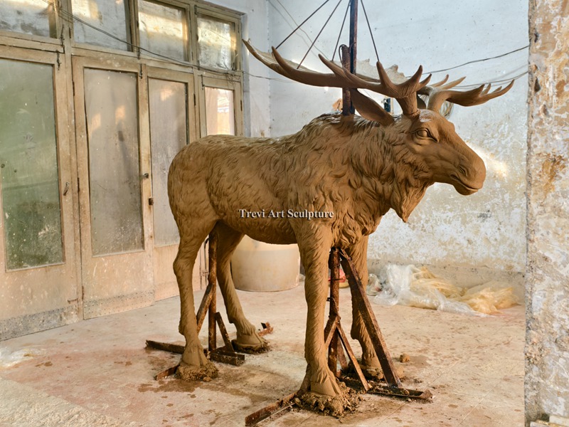 Hand-carved clay model of a moose, a different species from elk