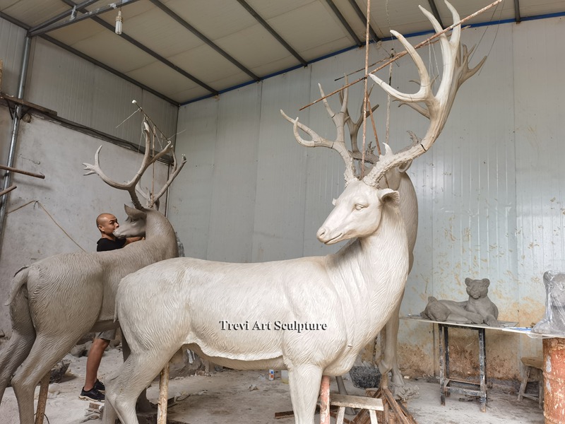 Sculptor working on a deer clay model