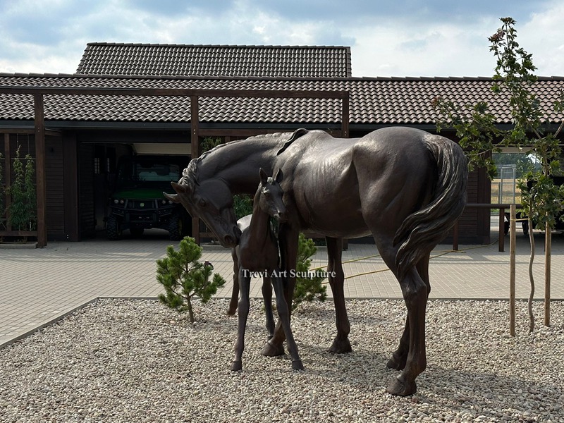 Bronze mare and foal sculpture installed at a customer property