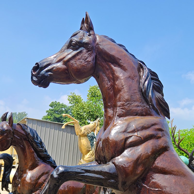 Close view of a bronze horse's head, neck and sculpted musculature